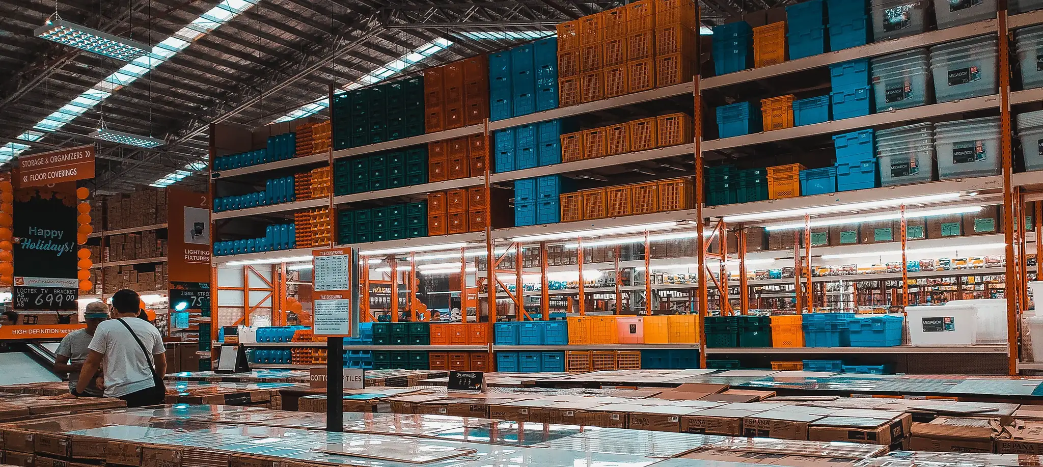 Warehouse aisles stacked with building supplies and flooring